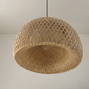 Woven rattan pendant light against a neutral background