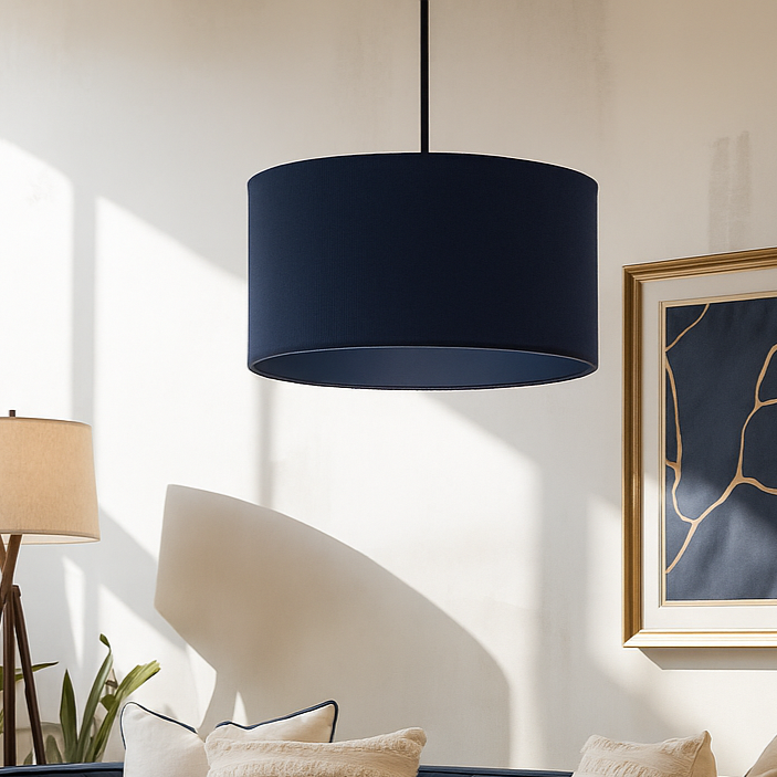 Modern living room with navy blue sofa, white pillows, and decorative elements.