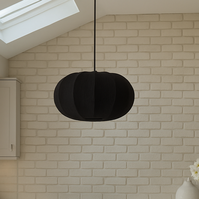 Modern kitchen with white island, stools, and brick wall.