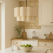 Modern kitchen with white countertops, wooden cabinets, and a pendant light.