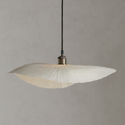 Pendant light with ribbed glass shade on a gray background
