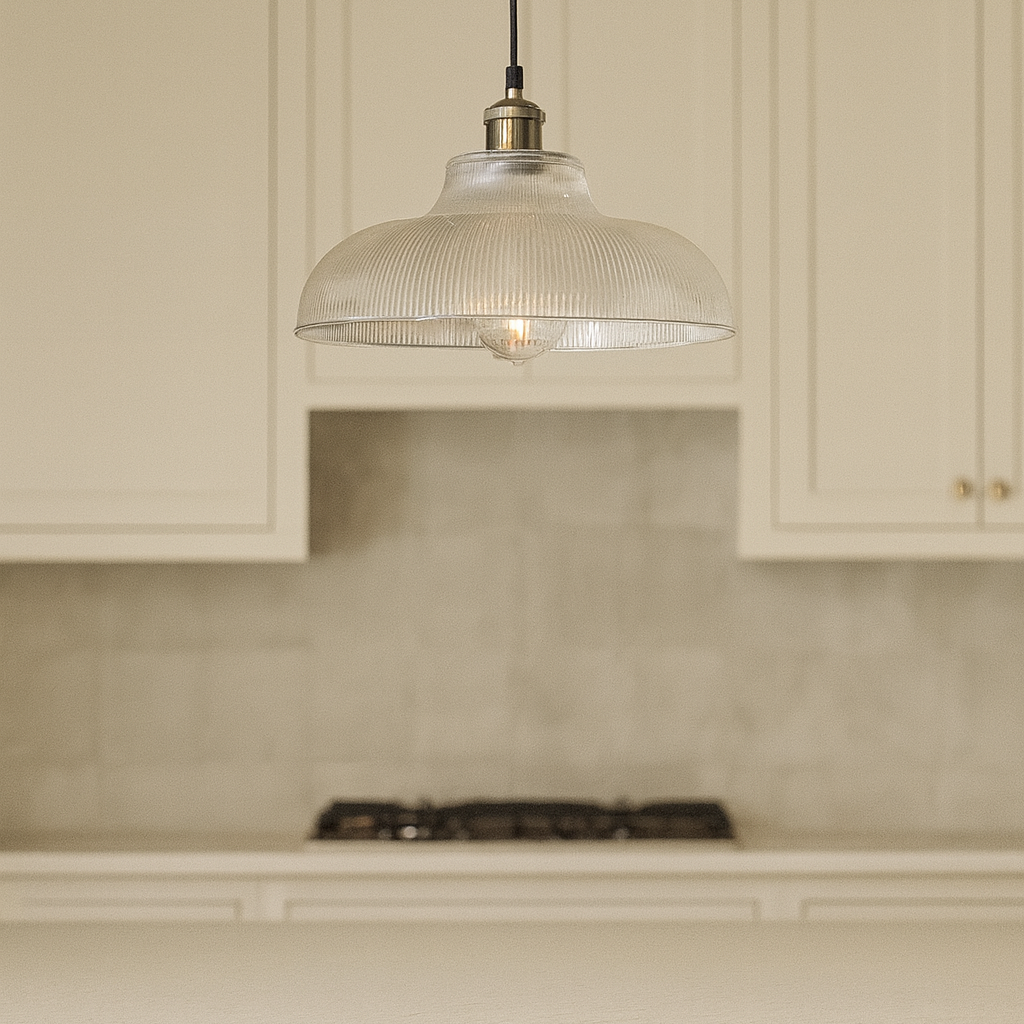 Kitchen with beige cabinets and a pendant light fixture.