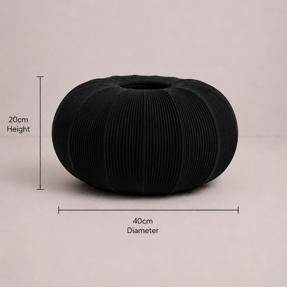 Black textured vase with measurements on a beige background