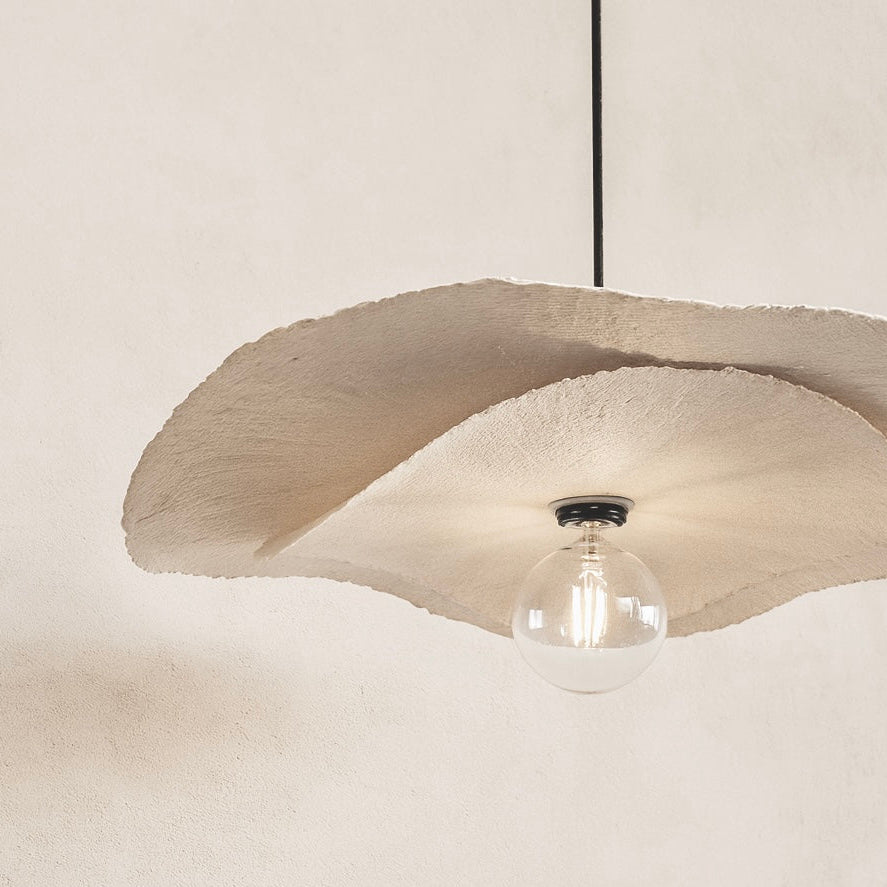 Ceiling light fixture with a beige lampshade on a plain background