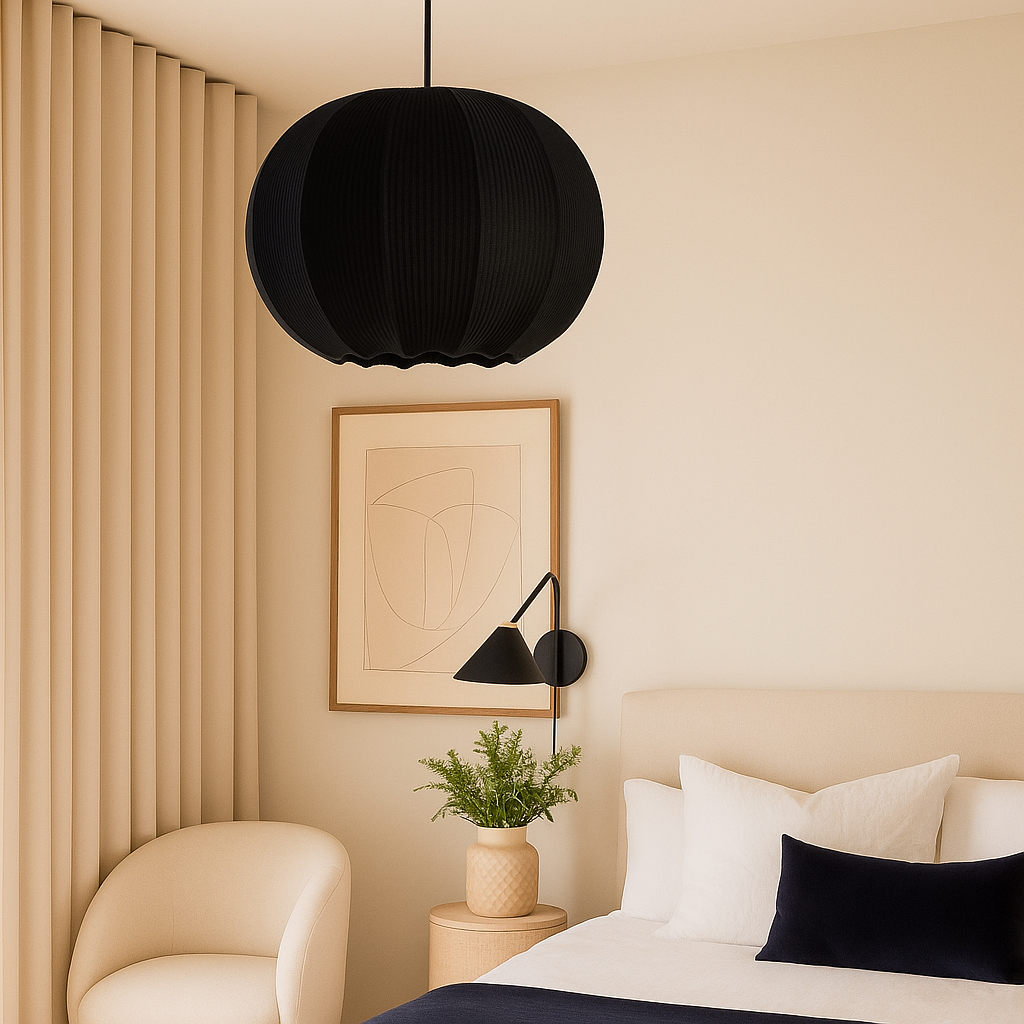 Modern bedroom interior with black pendant lamp, beige walls, and a bed with white and black pillows.