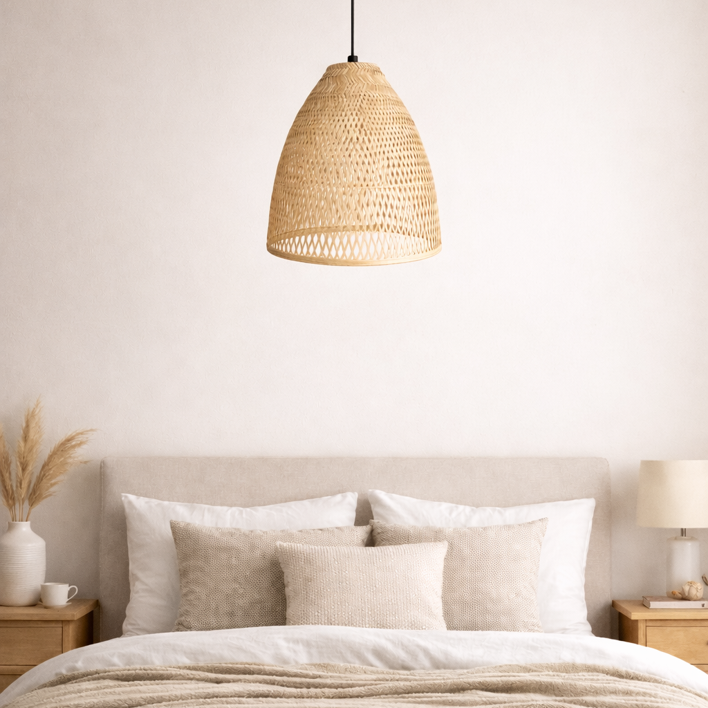 Neatly made bed with neutral bedding and pillows in a bedroom setting.