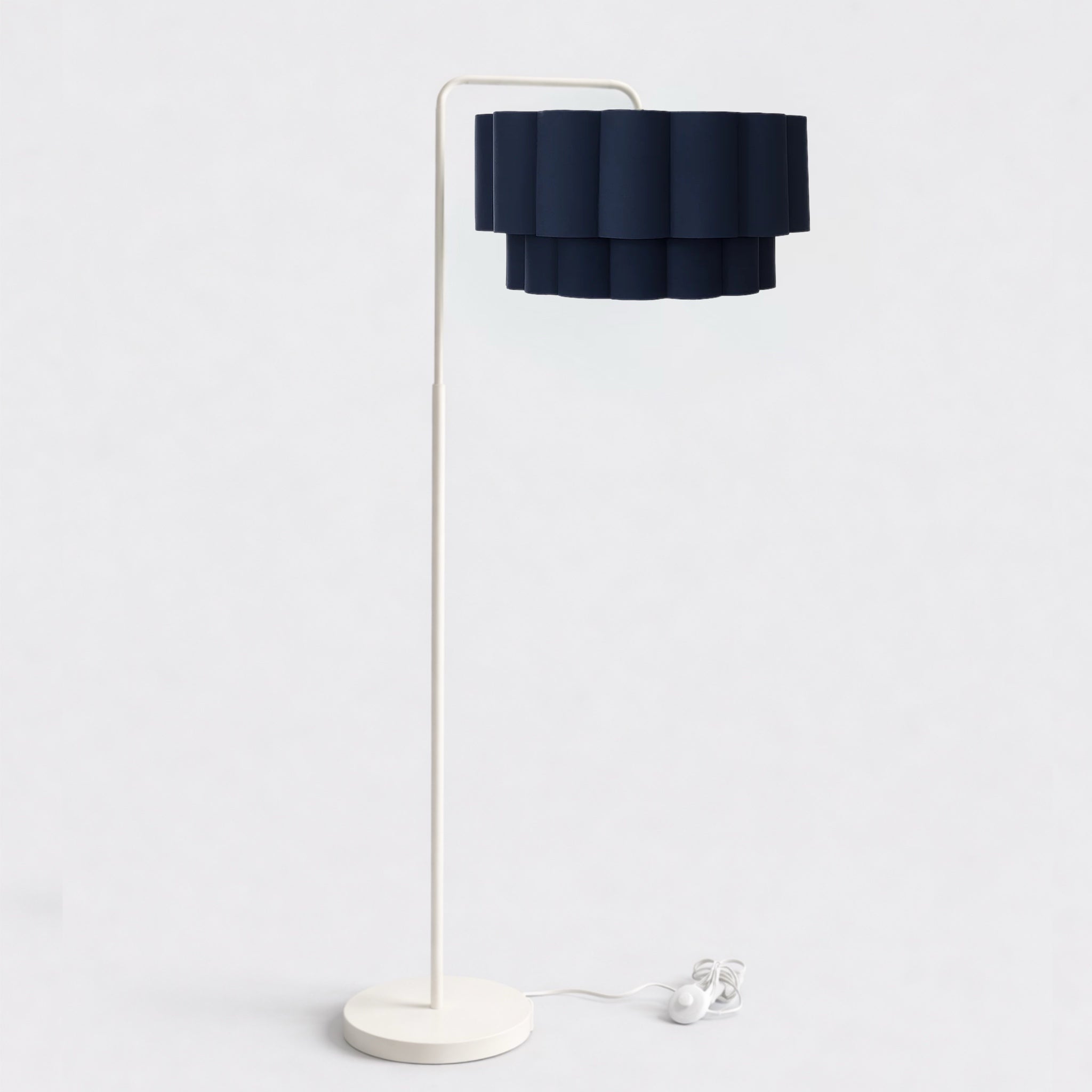 Floor lamp with a dark blue shade and white base on a light gray background