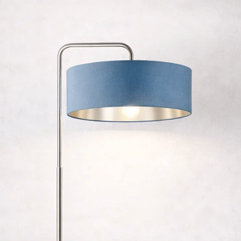 Floor lamp with a blue shade in a living room setting.