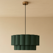 Green pendant light hanging against a beige wall