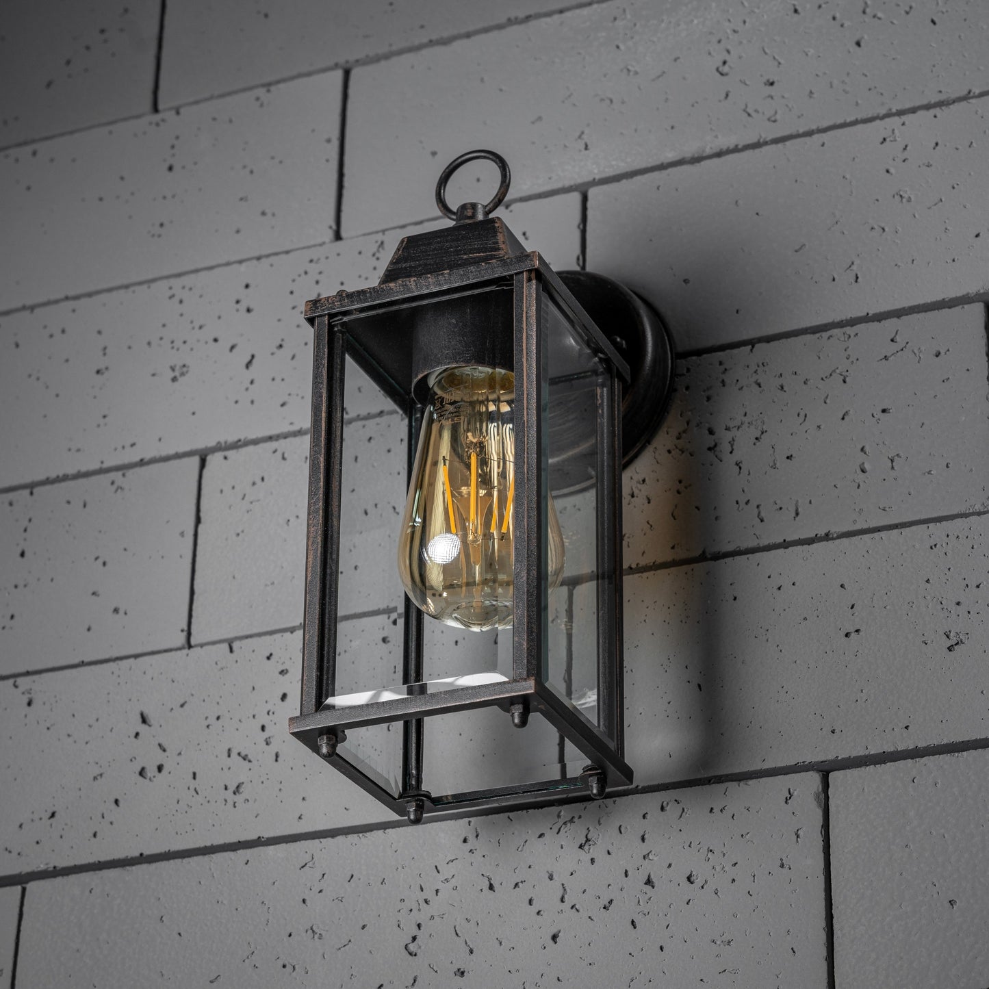 If you’re looking for a modern take on a traditional outdoor wall light, this glass coach wall light is perfect for adding style and protection for your home. This classic lantern light is designed with a contemporary twist, styled with a cuboid shape and fitted with glass windows that allow the light to shine effectively.&nbsp;