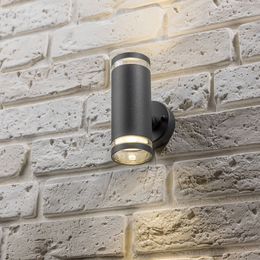 Our Jennifer dark grey outdoor wall mounted up and down cylinder outdoor light would look perfect in a modern or more traditional home design. Outside wall lights can provide atmospheric light in your garden, at the front door or on the terrace as well as a great security solution. It is designed for durability and longevity with its robust material producing a fully weatherproof and water resistant light fitting