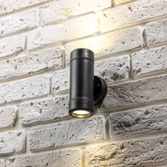 Our Valentine black outdoor wall mounted up and down cylinder outdoor light would look perfect in a modern or more traditional home design. Outside wall lights can provide atmospheric light in your garden, at the front door or on the terrace as well as a great security solution. It is designed for durability and longevity with its robust material producing a fully weatherproof and water-resistant light fitting. Use LED bulbs to make this light energy efficient and low cost to run.