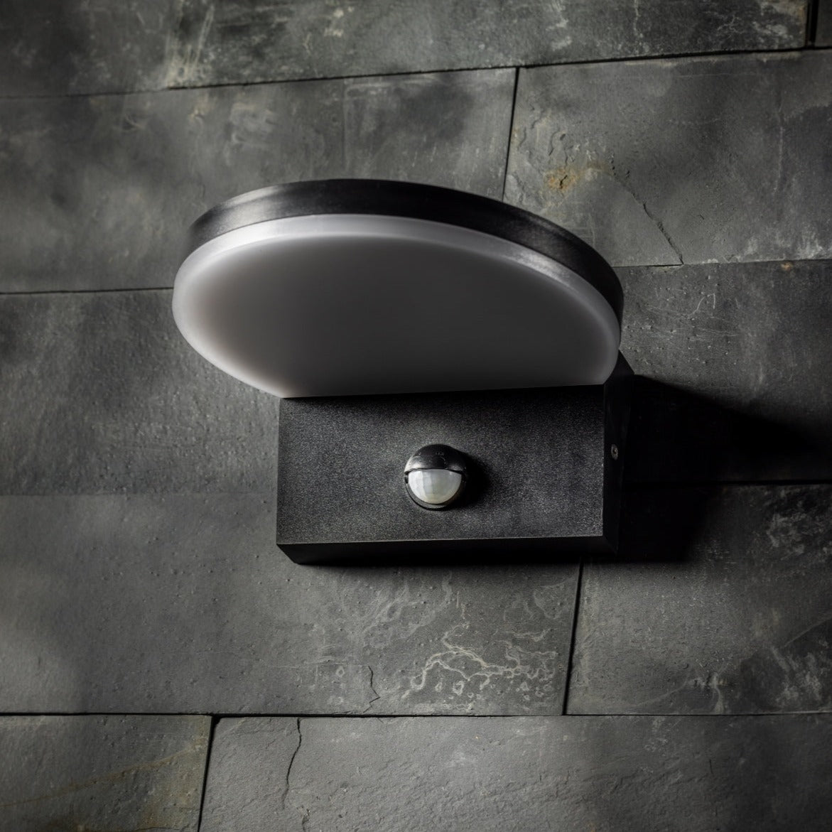 Our Aubrey black plastic ABS plastic outdoor wall mounted round outdoor light with built in LED's and motion sensor would look perfect in a modern or more traditional home design. Outside wall lights can provide atmospheric light in your garden, at the front door or on the terrace as well as a great security solution. It is designed for durability and longevity with its robust material producing a fully weatherproof and water resistant light fitting.