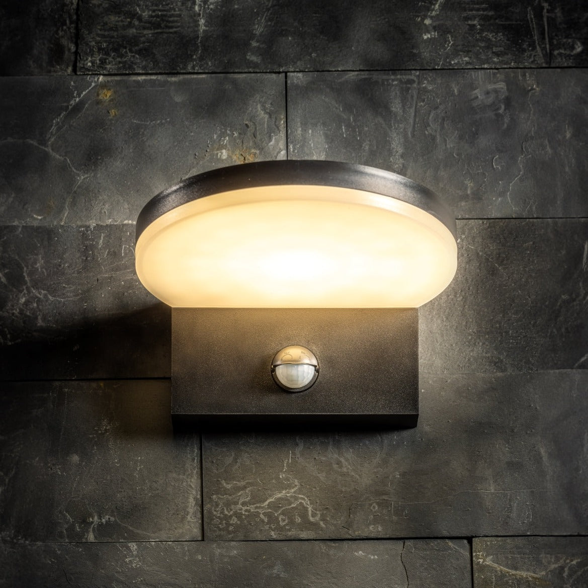 Our Aubrey black plastic ABS plastic outdoor wall mounted round outdoor light with built in LED's and motion sensor would look perfect in a modern or more traditional home design. Outside wall lights can provide atmospheric light in your garden, at the front door or on the terrace as well as a great security solution. It is designed for durability and longevity with its robust material producing a fully weatherproof and water resistant light fitting.