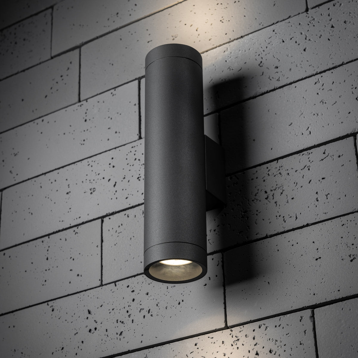 Our Lucas grey anthracite extra long outdoor wall mounted up and down cylinder outdoor light would look perfect in a modern or more traditional home design. Outside wall lights can provide atmospheric light in your garden, at the front door or on the terrace as well as a great security solution. It is designed for durability and longevity with its robust material producing a fully weatherproof and water resistant light fitting.