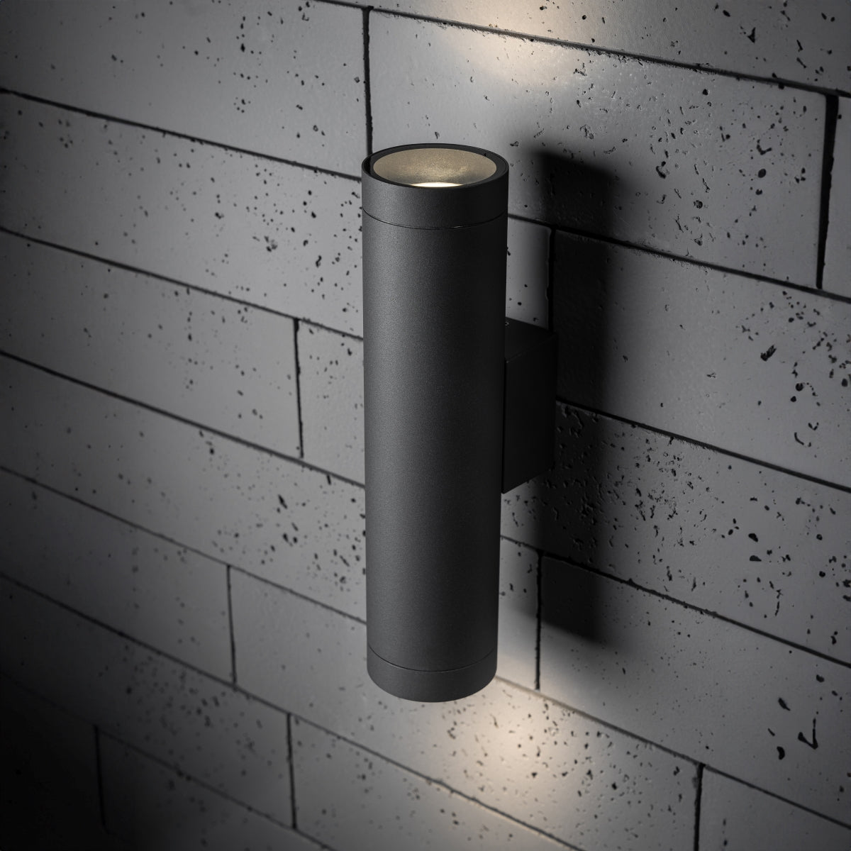 Our Lucas grey anthracite extra long outdoor wall mounted up and down cylinder outdoor light would look perfect in a modern or more traditional home design. Outside wall lights can provide atmospheric light in your garden, at the front door or on the terrace as well as a great security solution. It is designed for durability and longevity with its robust material producing a fully weatherproof and water resistant light fitting.