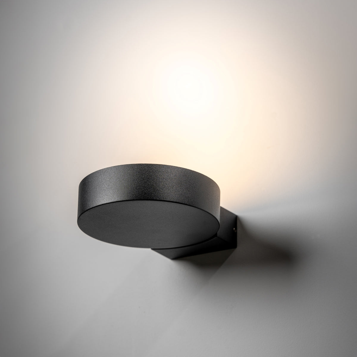 Our Darcy black die cast aluminium wall mounted round outdoor light with built in LED's would look perfect in a modern or more traditional home design. Comes with an adjustable head to allow you to angle the light output to your desired look.