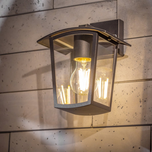 If you’re looking for a modern take on a traditional outdoor wall light, this black lantern  wall light with clear diffuser is perfect for adding style and protection for your home. This classic design with a contemporary twist, styled with a metal lantern shape and fitted with clear polycarbonate diffusers that allows the light to shine effectively.  This product also contains an imposing black finish, making it ideal for any home design - adding a statement to any wall it fits in