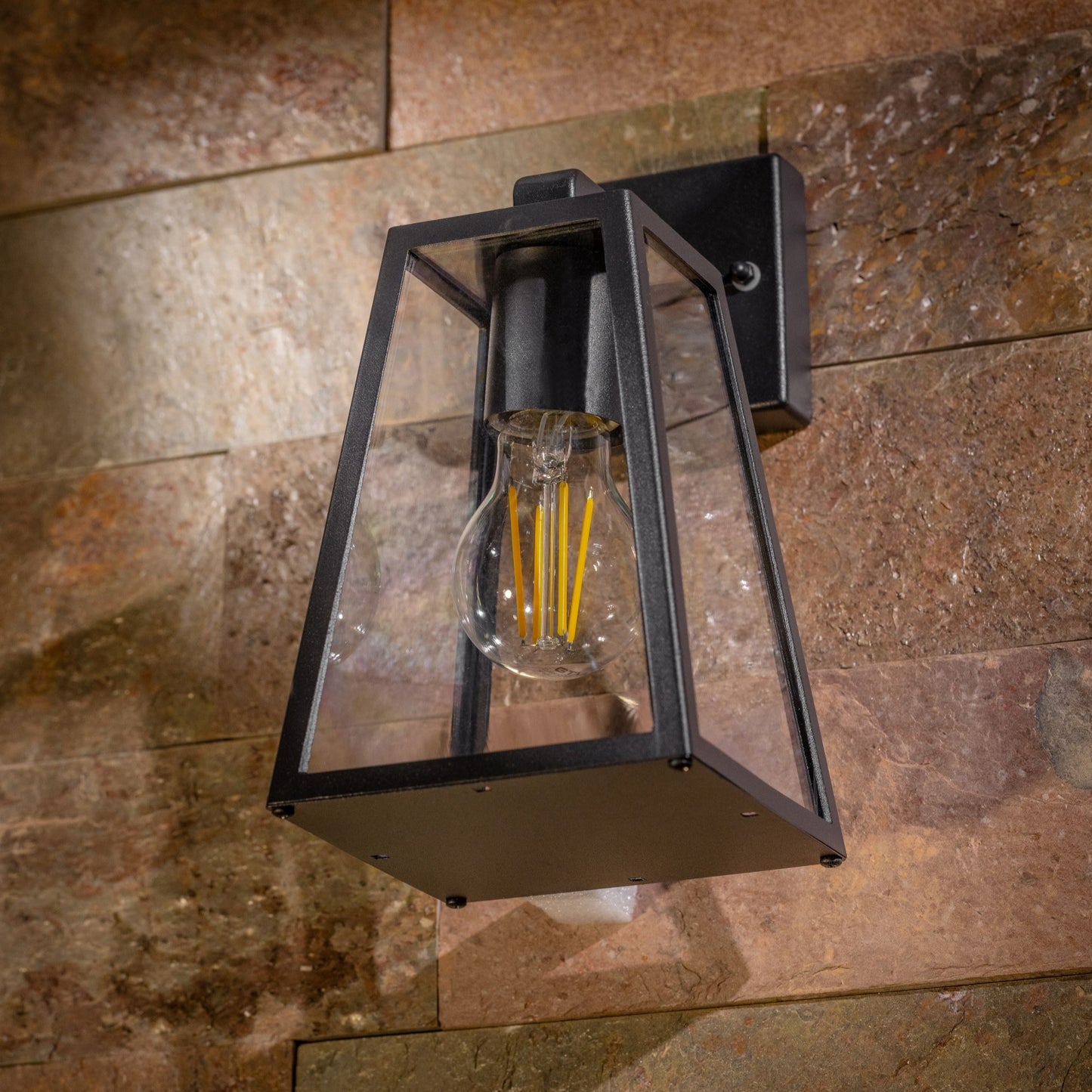 If you’re looking for a modern take on a traditional outdoor wall light, this black aluminium triangular wall light is perfect for adding style and protection for your home. This classic design with a contemporary twist, styled with a metal triangle shape and fitted with clear diffusers also contains an imposing black finish, making it ideal for any home design - adding a statement to any wall it fits in. Create an inviting glow over your garden and home with our Callie wall light by CGC Interiors.