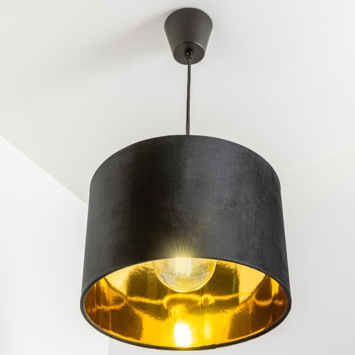 Our Nila velvet shade is sophisticated in appearance and we have designed the shade to  suit a range of interiors. Easy to fit, it’s crafted from high-quality velvet on the outer and has a reflective gold metallic inner. It's made to fit both a ceiling light or lamp base