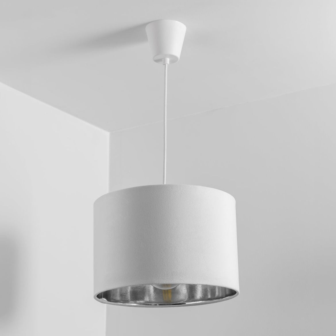 Our Nila velvet shade is sophisticated in appearance and we have designed the shade to  suit a range of interiors. Easy to fit, it’s crafted from high-quality velvet on the outer and has a reflective Silver metallic inner. It's made to fit both a ceiling light or lamp base.