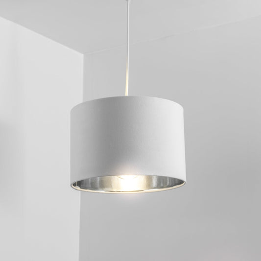 Our Nila velvet shade is sophisticated in appearance and we have designed the shade to  suit a range of interiors. Easy to fit, it’s crafted from high-quality velvet on the outer and has a reflective Silver metallic inner. It's made to fit both a ceiling light or lamp base.