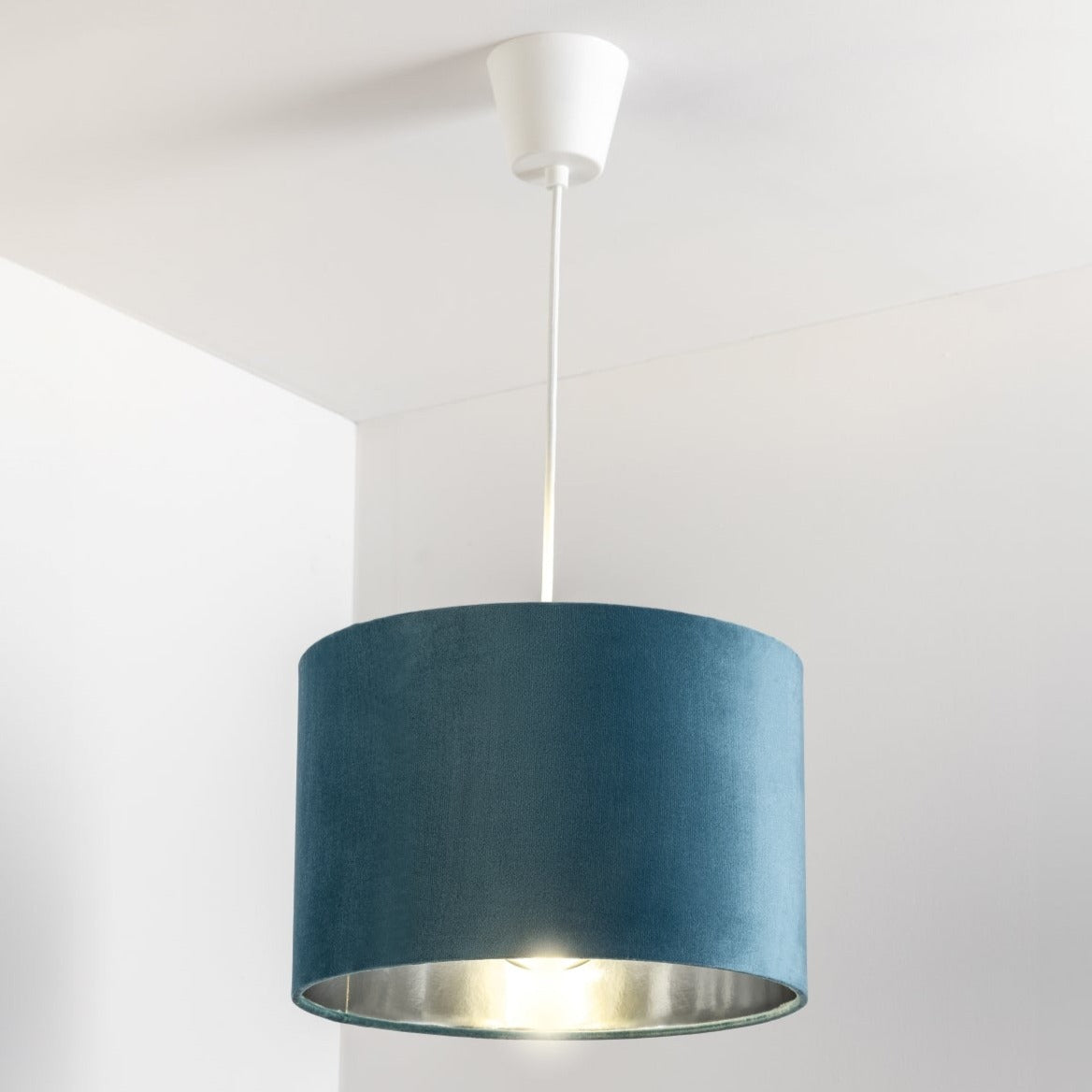 Our Nila velvet shade is sophisticated in appearance and we have designed the shade to  suit a range of interiors. Easy to fit, it’s crafted from high-quality velvet on the outer and has a reflective silver metallic inner. It's made to fit both a ceiling light or lamp base.