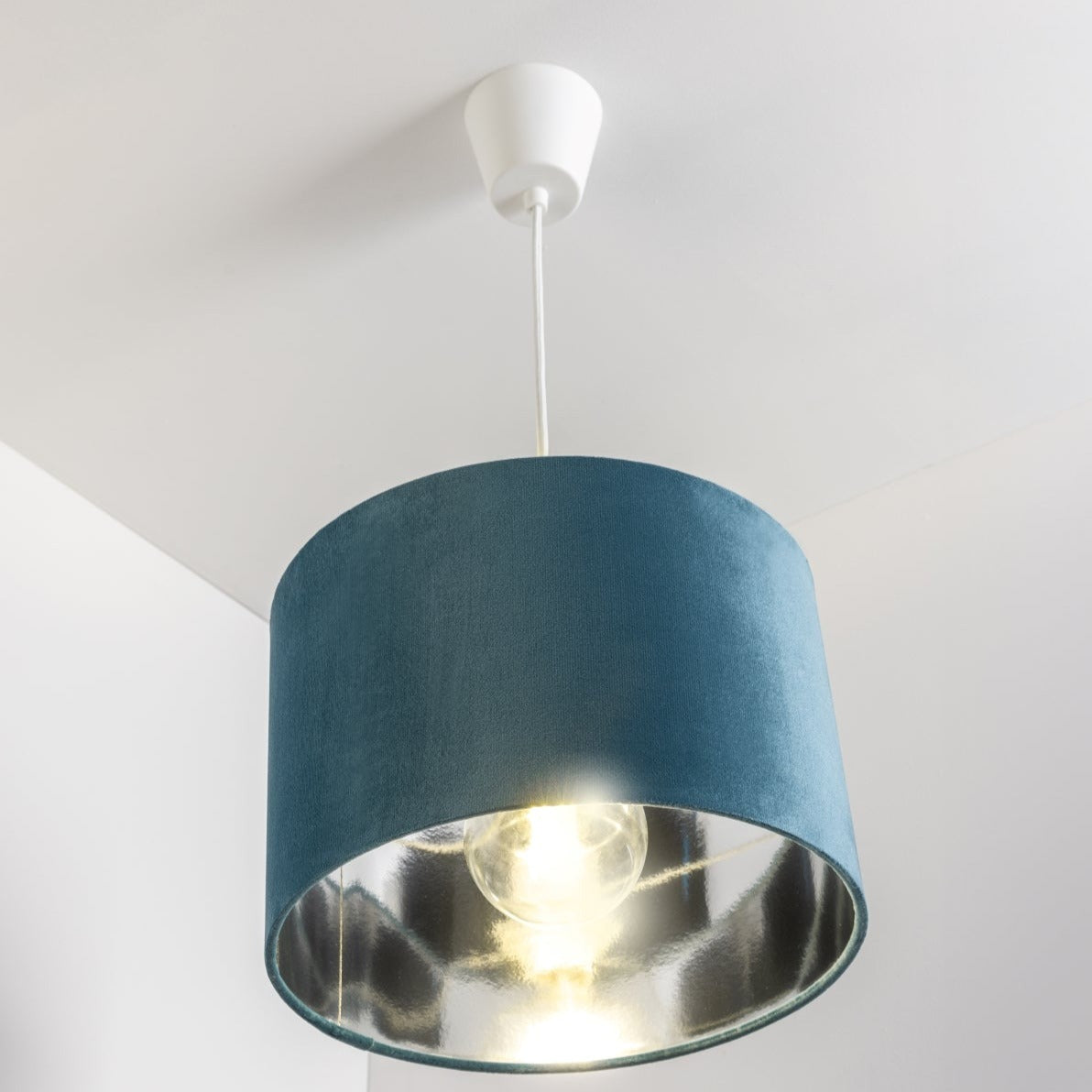 Our Nila velvet shade is sophisticated in appearance and we have designed the shade to  suit a range of interiors. Easy to fit, it’s crafted from high-quality velvet on the outer and has a reflective silver metallic inner. It's made to fit both a ceiling light or lamp base.
