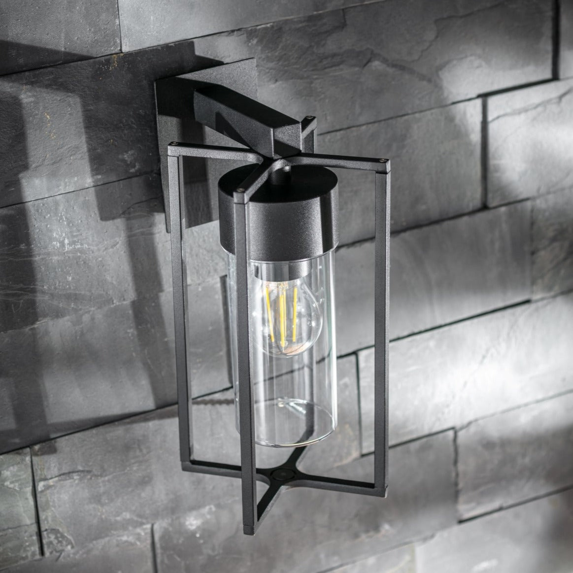 If you’re looking for a modern take on a traditional outdoor wall light, this black lantern wall light with clear diffuser is perfect for adding style and protection for your home. This classic design with a contemporary twist, styled with a metal lantern shape and fitted with a cylinder diffuser that allows the light to shine effectively