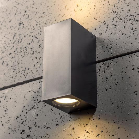 Our Eileen black up and down wall mounted rectangle outdoor light would look perfect in a modern or more traditional home design. Outside wall lights can provide atmospheric light in your garden, at the front door or on the terrace as well as a great security solution. It is designed for durability and longevity with its robust material producing a fully weatherproof and water resistant light fitting.