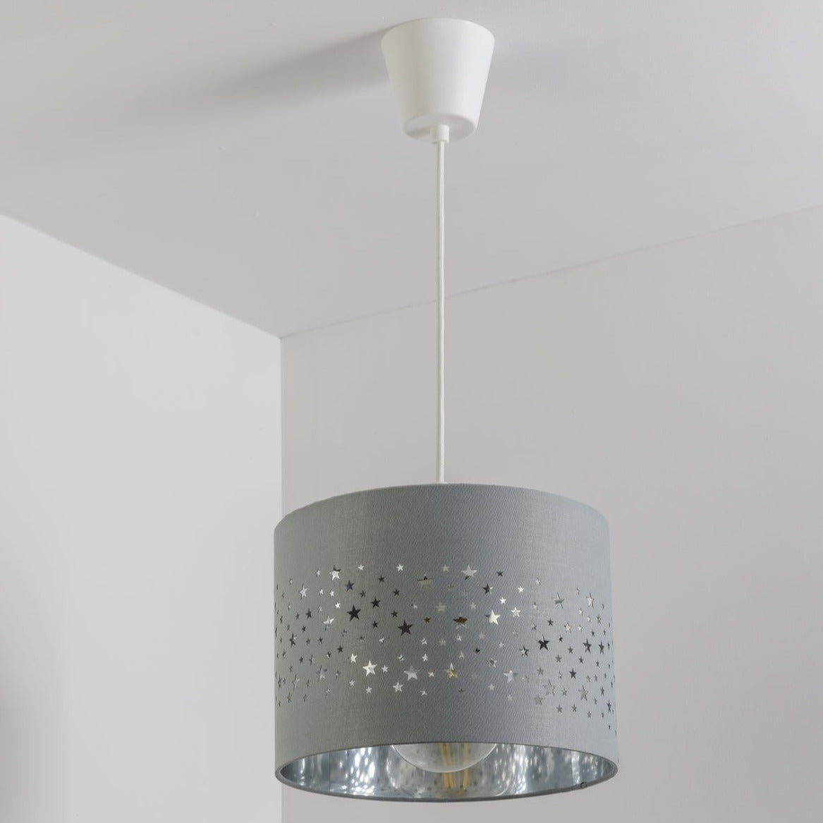 The Stardust luxury grey fabric star pendant shade would make a charming touch to your room. Constructed from a high quality soft grey cotton material with intricate laser cut stars in various sizes making a stunning effect in the room when lit