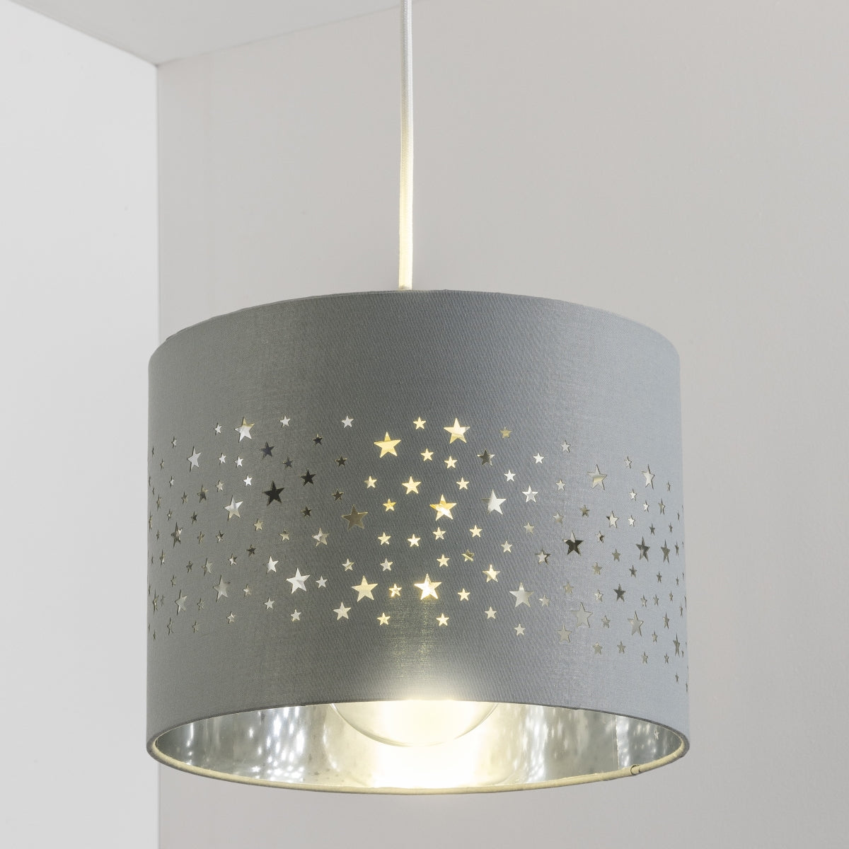 The Stardust luxury grey fabric star pendant shade would make a charming touch to your room. Constructed from a high quality soft grey cotton material with intricate laser cut stars in various sizes making a stunning effect in the room when lit