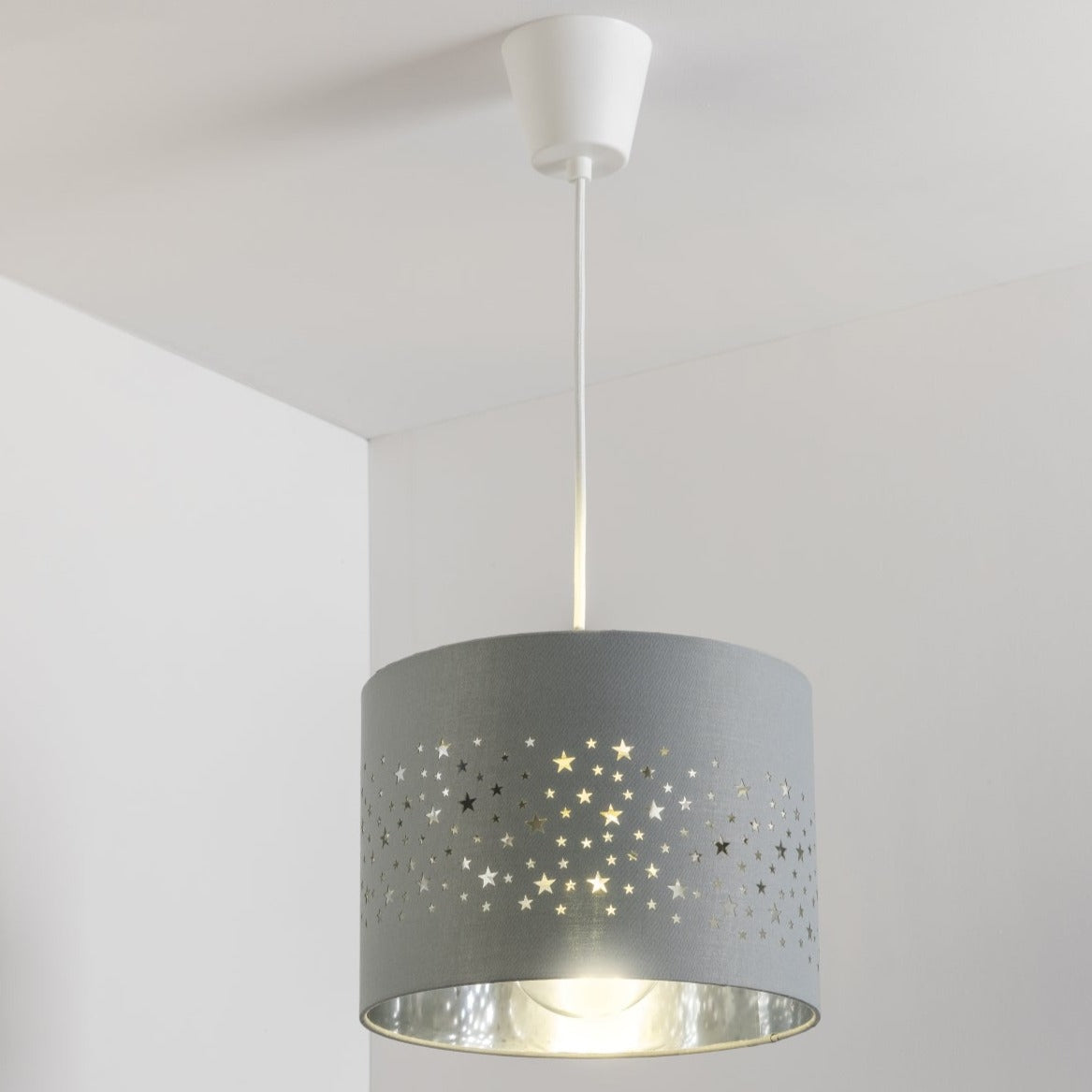 The Stardust luxury grey fabric star pendant shade would make a charming touch to your room. Constructed from a high quality soft grey cotton material with intricate laser cut stars in various sizes making a stunning effect in the room when lit