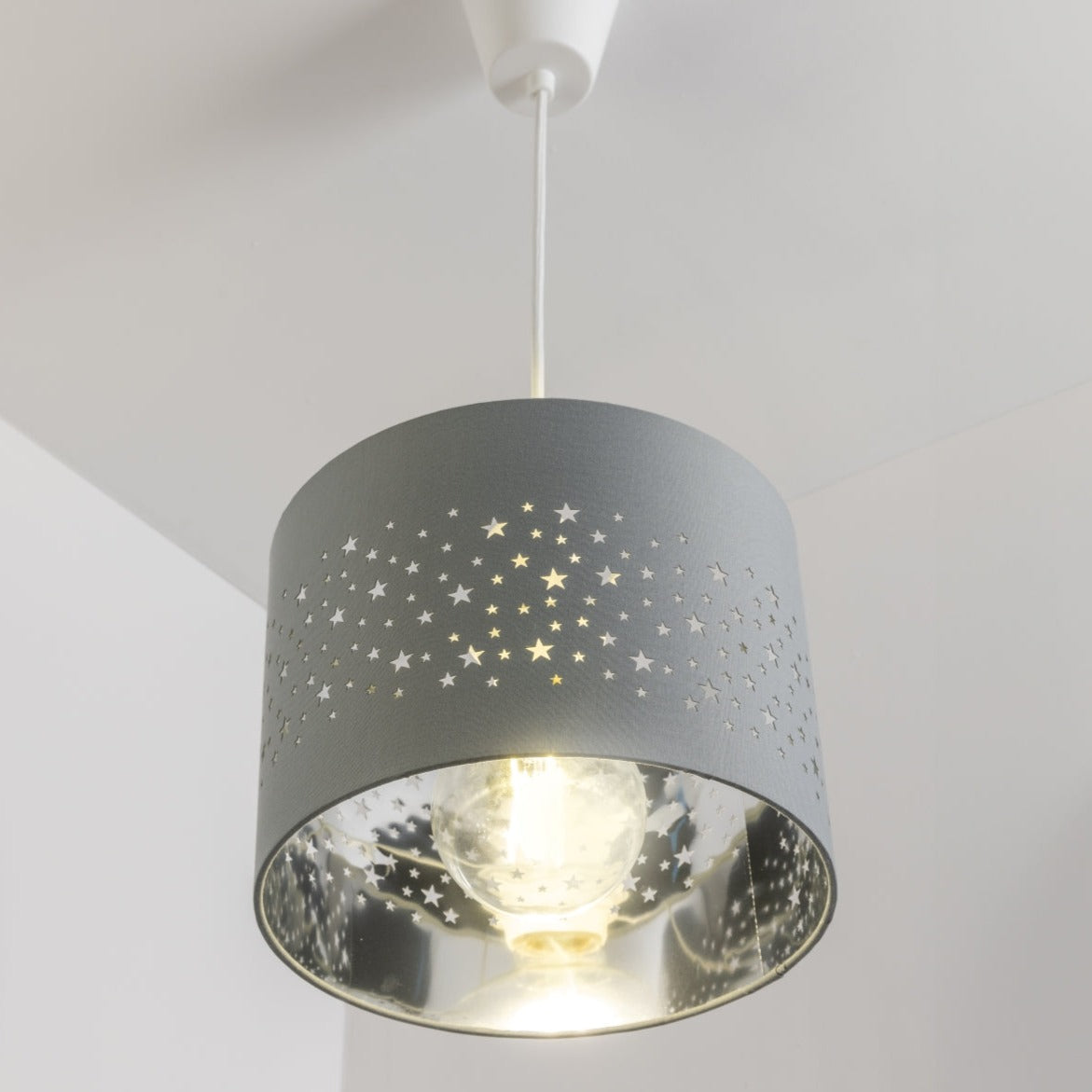 The Stardust luxury grey fabric star pendant shade would make a charming touch to your room. Constructed from a high quality soft grey cotton material with intricate laser cut stars in various sizes making a stunning effect in the room when lit