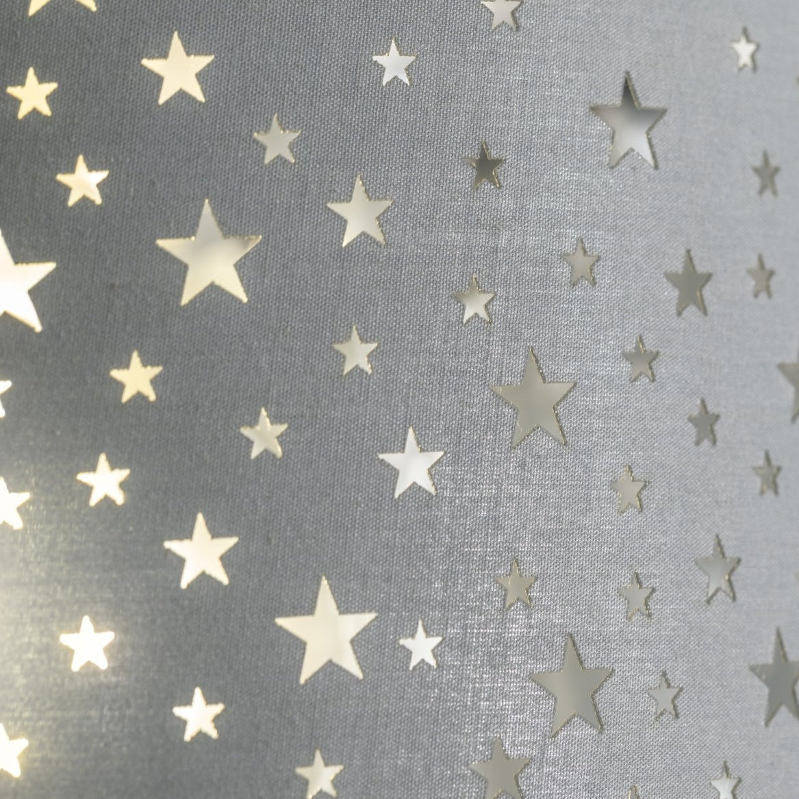 The Stardust luxury grey fabric star pendant shade would make a charming touch to your room. Constructed from a high quality soft grey cotton material with intricate laser cut stars in various sizes making a stunning effect in the room when lit