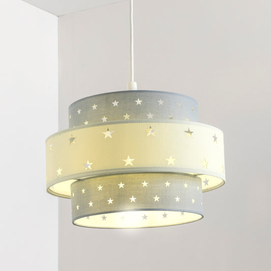 Our Grey and Cream two tiered star shade features a mixture of large and small sweet stars cut out across a grey and cream background. When your lamp is turned on it will shine out through these cut-outs, mimicking a beautiful night sky. This lampshade is made with soft-touch fabric for a little bit of luxury.