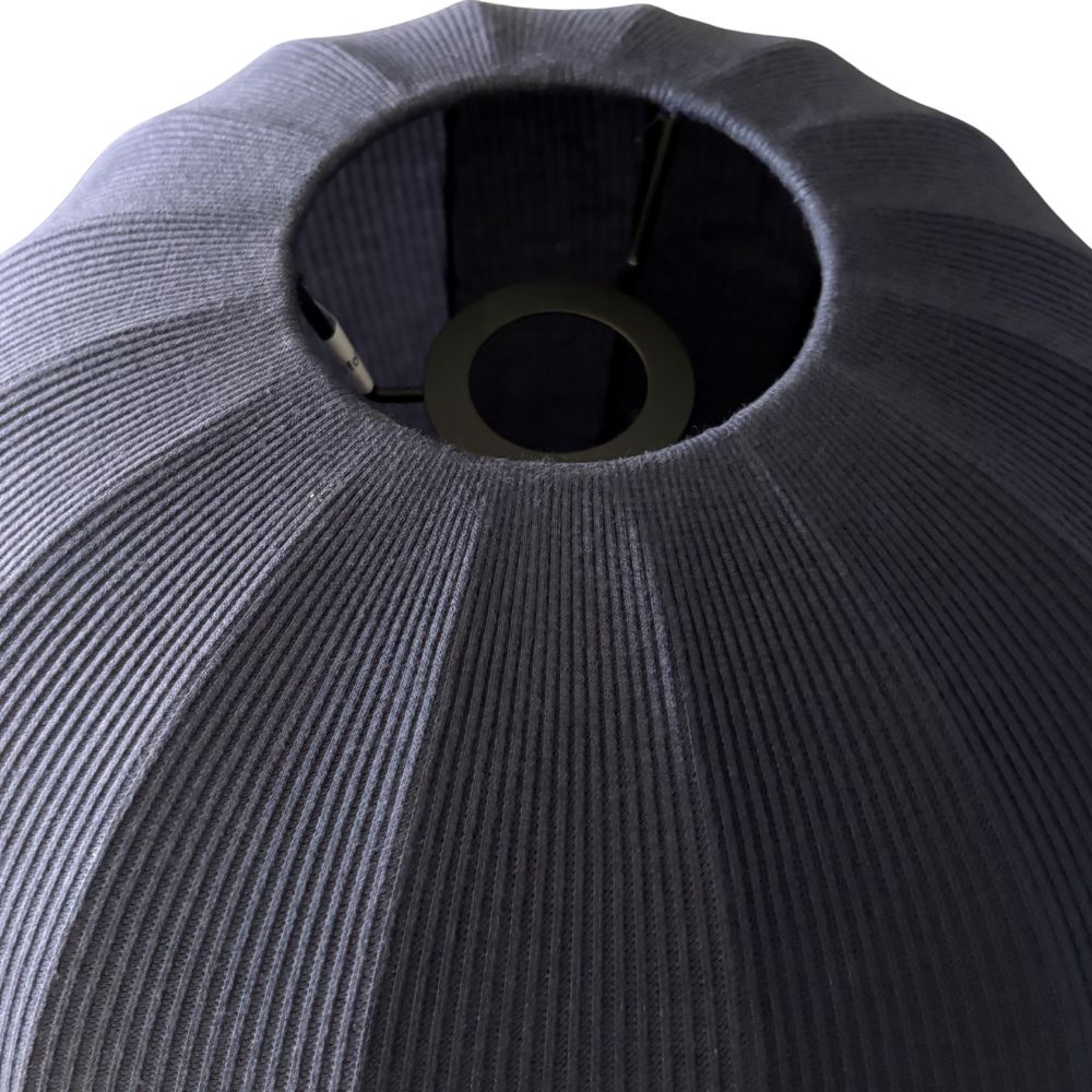 Close-up of a textured gray cushion with a circular cutout on a white background