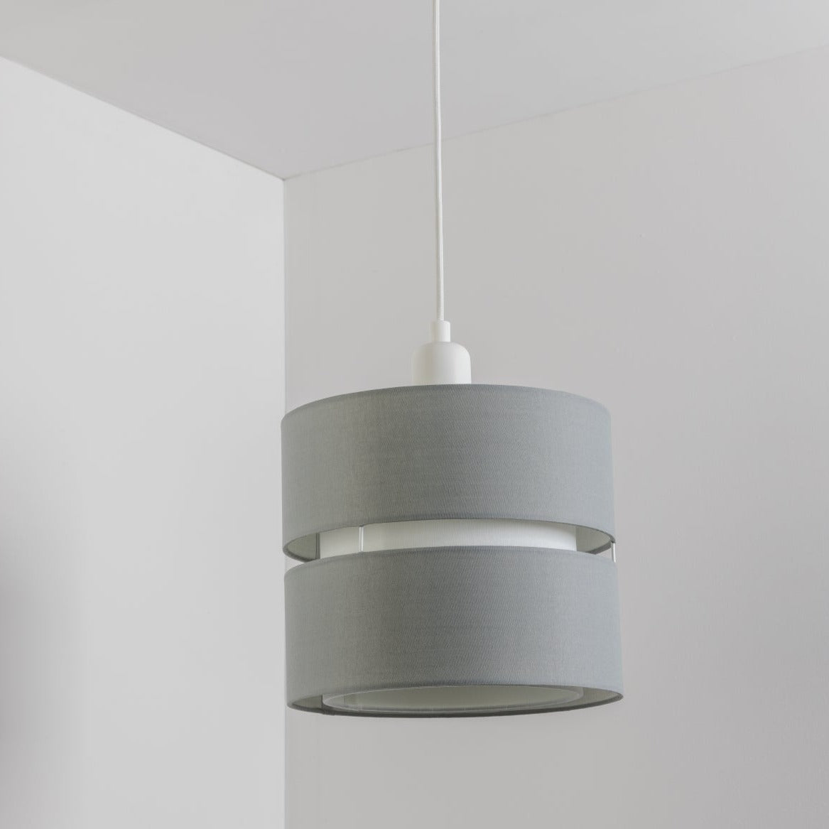 Our Gayle easy-fit two tiered luxury fabric double layered shade is contemporary in its appearance and we have designed the shade to suit a range of interiors. Easy to fit simply attached to an existing pendant flitting.  It is crafted from high quality fabric material in two layers and complimented with a white inner which looks beautiful when light shines through.