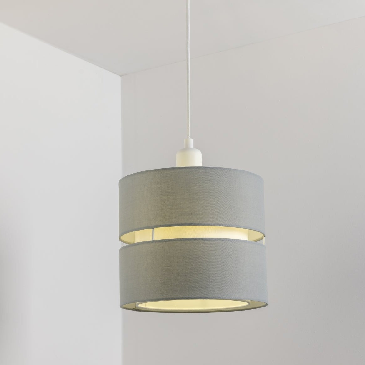 Our Gayle easy-fit two tiered luxury fabric double layered shade is contemporary in its appearance and we have designed the shade to suit a range of interiors. Easy to fit simply attached to an existing pendant flitting.  It is crafted from high quality fabric material in two layers and complimented with a white inner which looks beautiful when light shines through.