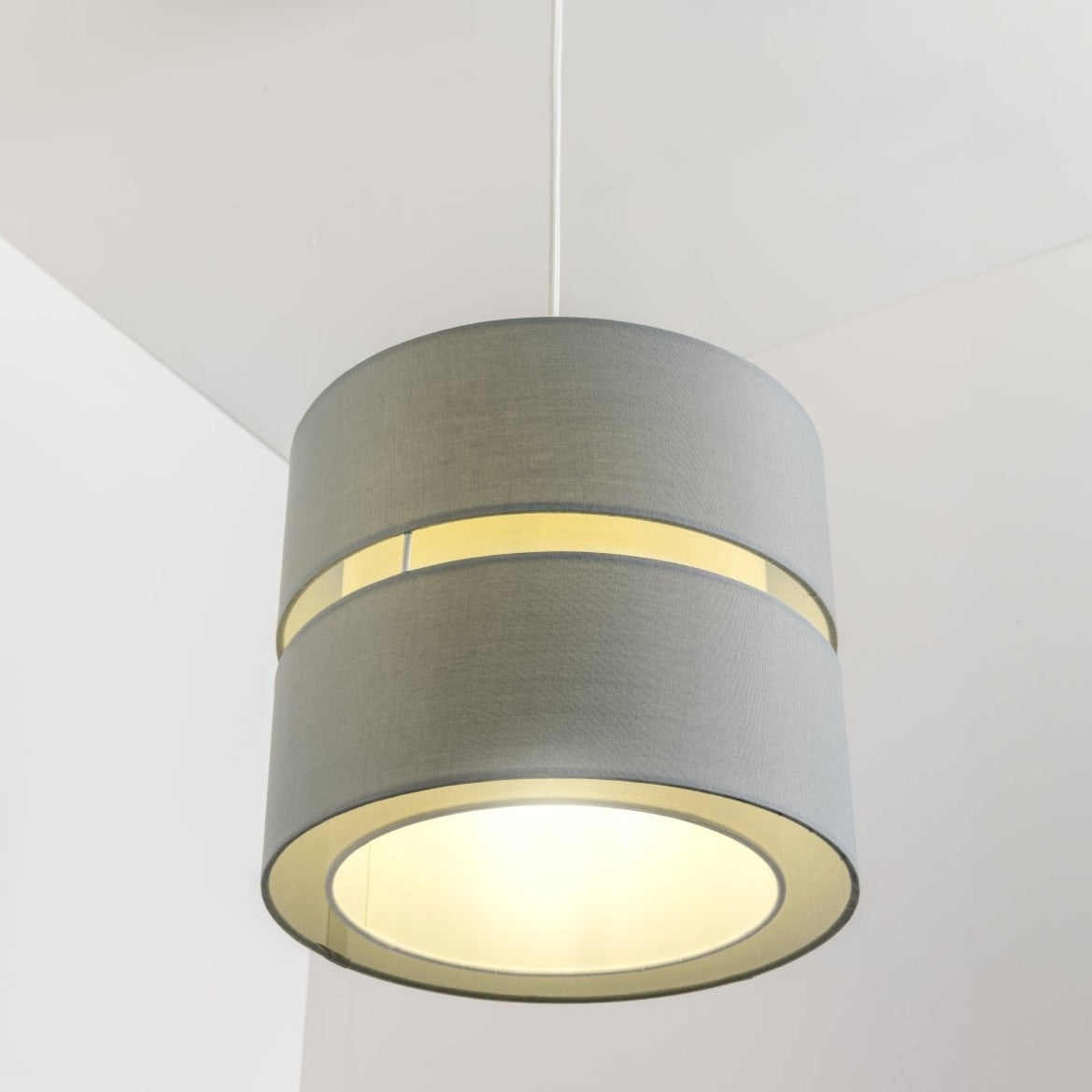 Our Gayle easy-fit two tiered luxury fabric double layered shade is contemporary in its appearance and we have designed the shade to suit a range of interiors. Easy to fit simply attached to an existing pendant flitting.  It is crafted from high quality fabric material in two layers and complimented with a white inner which looks beautiful when light shines through.