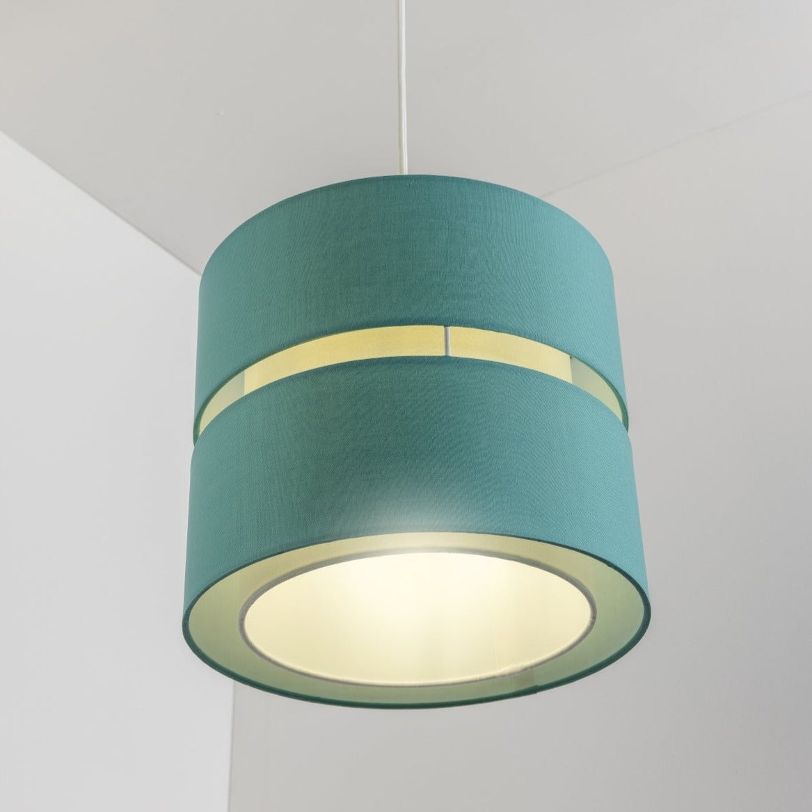 Our Gayle easy-fit two tiered luxury fabric double layered shade is contemporary in its appearance and we have designed the shade to suit a range of interiors. Easy to fit simply attached to an existing pendant flitting.  It is crafted from high quality fabric material in two layers and complimented with a white inner which looks beautiful when light shines through. The shade has been made to fit both a ceiling light or lamp base.