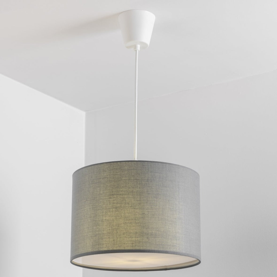 The Lucia is a modern cylinder drum shaped lamp shade in a luxury cotton finish and opal diffuser. This fantastic shade can double up as either a ceiling pendant light shade or table lampshade. Easily fits to your standard ceiling light fitting- no wiring required.