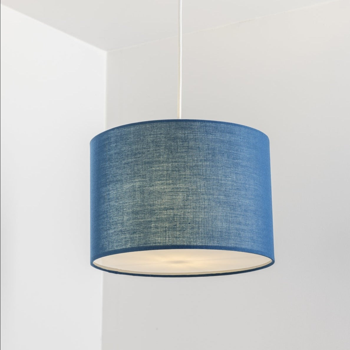 The Lucia is a modern cylinder drum shaped lamp shade in a luxury cotton finish and white opal diffuser. This fantastic shade can double up as either a ceiling pendant light shade or table lampshade. Easily fits to your standard ceiling light socket - no wiring required.
