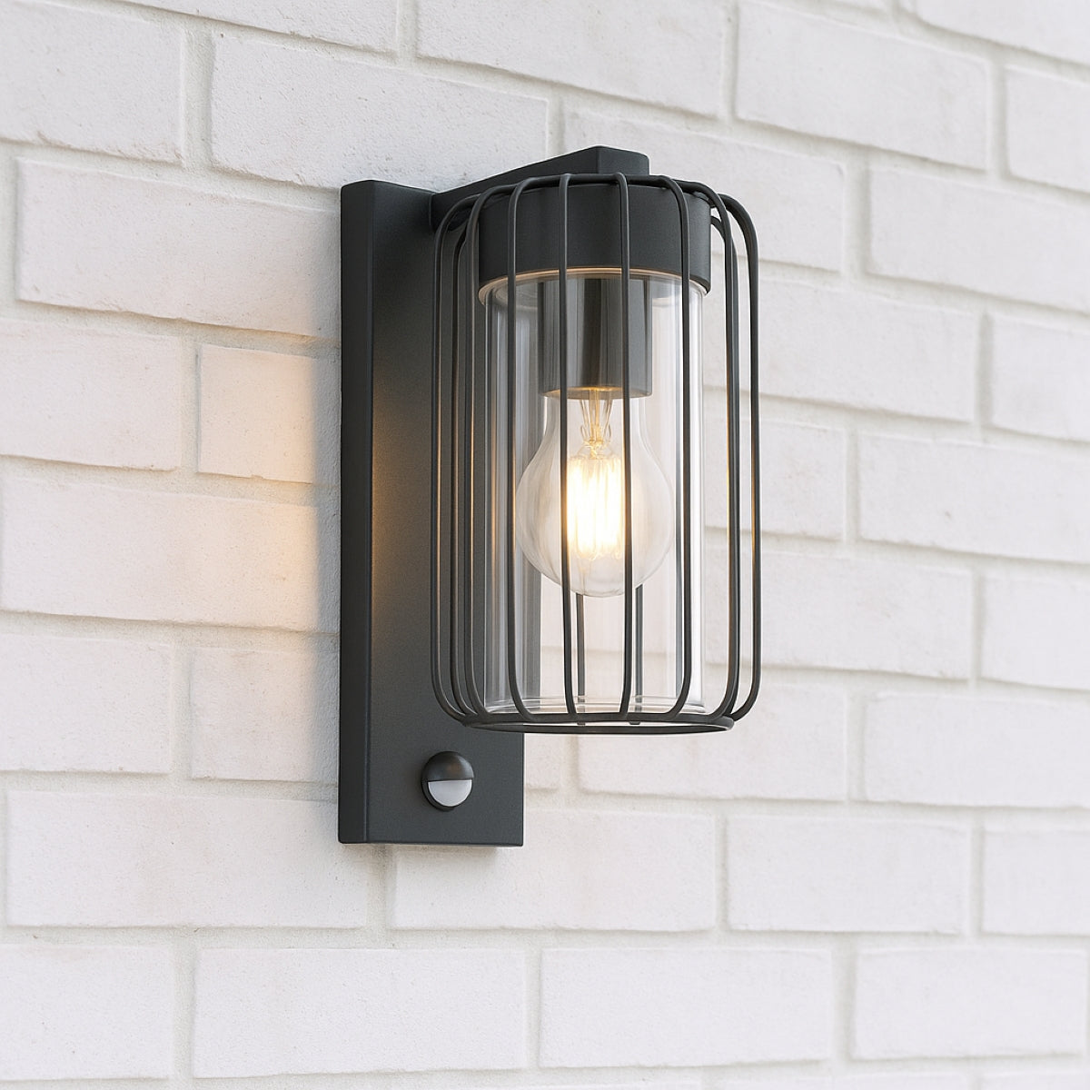 Black outdoor wall light fixture on a white brick wall
