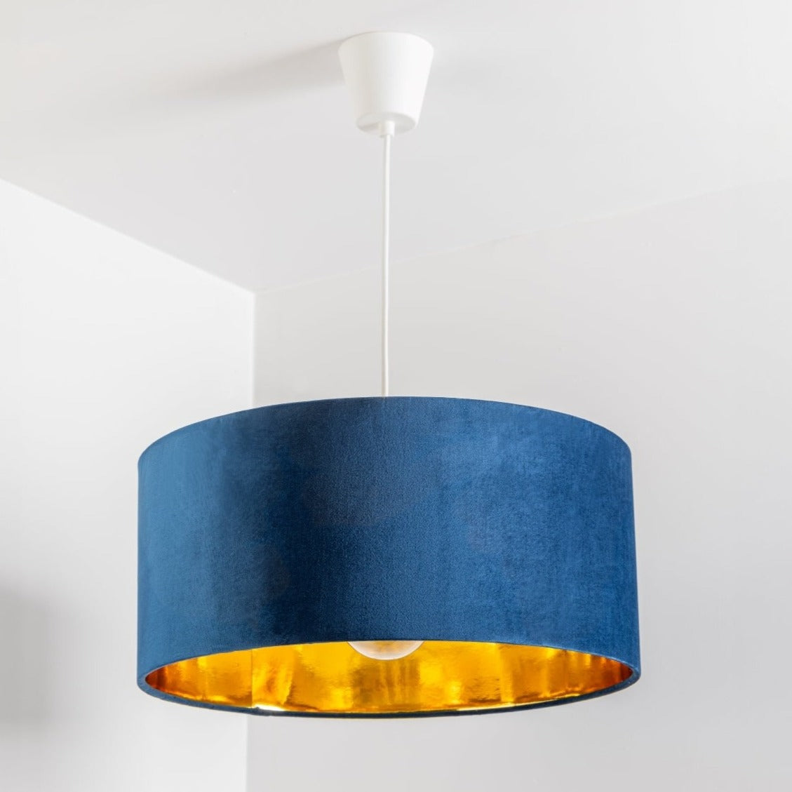 Our stunning oversized navy Milano lamp shade offers a timeless update to any room. The outer is made from high-quality navy blue velvet and the lining is reflective gold for a stylish finish. It’s easy to install and will instantly transforms your ceiling fitting, table or floor lamp. Simply attach to an existing light fitting or lamp base for an instant glow up.