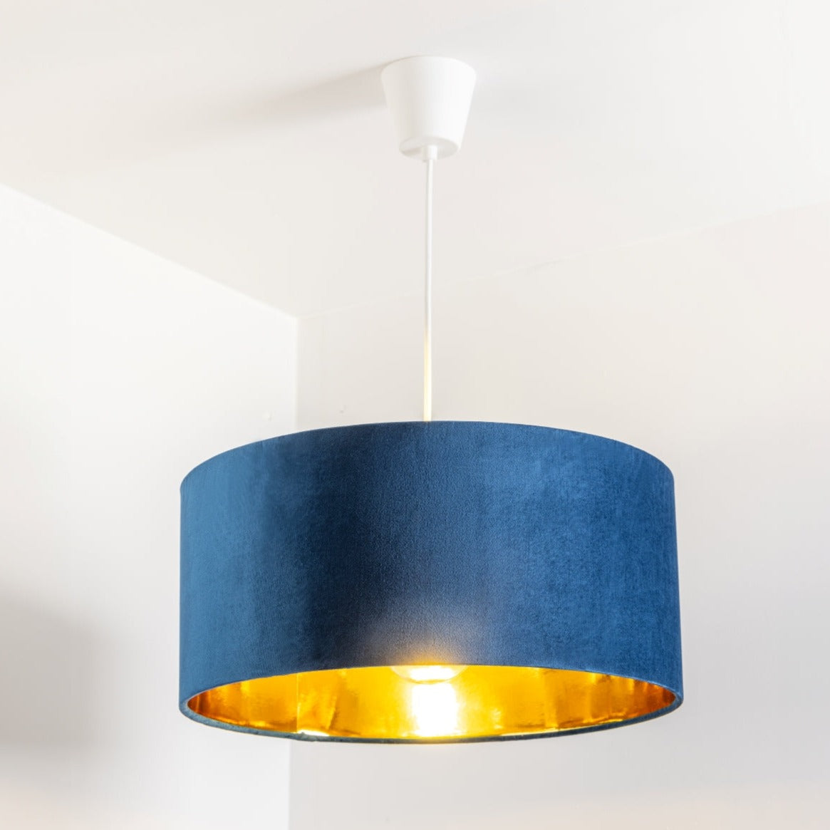 Our stunning oversized navy Milano lamp shade offers a timeless update to any room. The outer is made from high-quality navy blue velvet and the lining is reflective gold for a stylish finish. It’s easy to install and will instantly transforms your ceiling fitting, table or floor lamp. Simply attach to an existing light fitting or lamp base for an instant glow up.