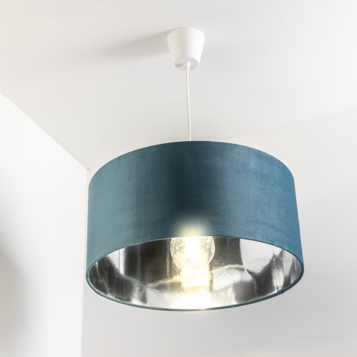 Our stunning oversized Teal blue/green Milano Lamp shade offers a timeless update to any room. The outer is made from high-quality velvet and the lining is reflective silver for a stylish finish. It’s easy to install and will instantly transforms your ceiling fitting, table or floor lamp.