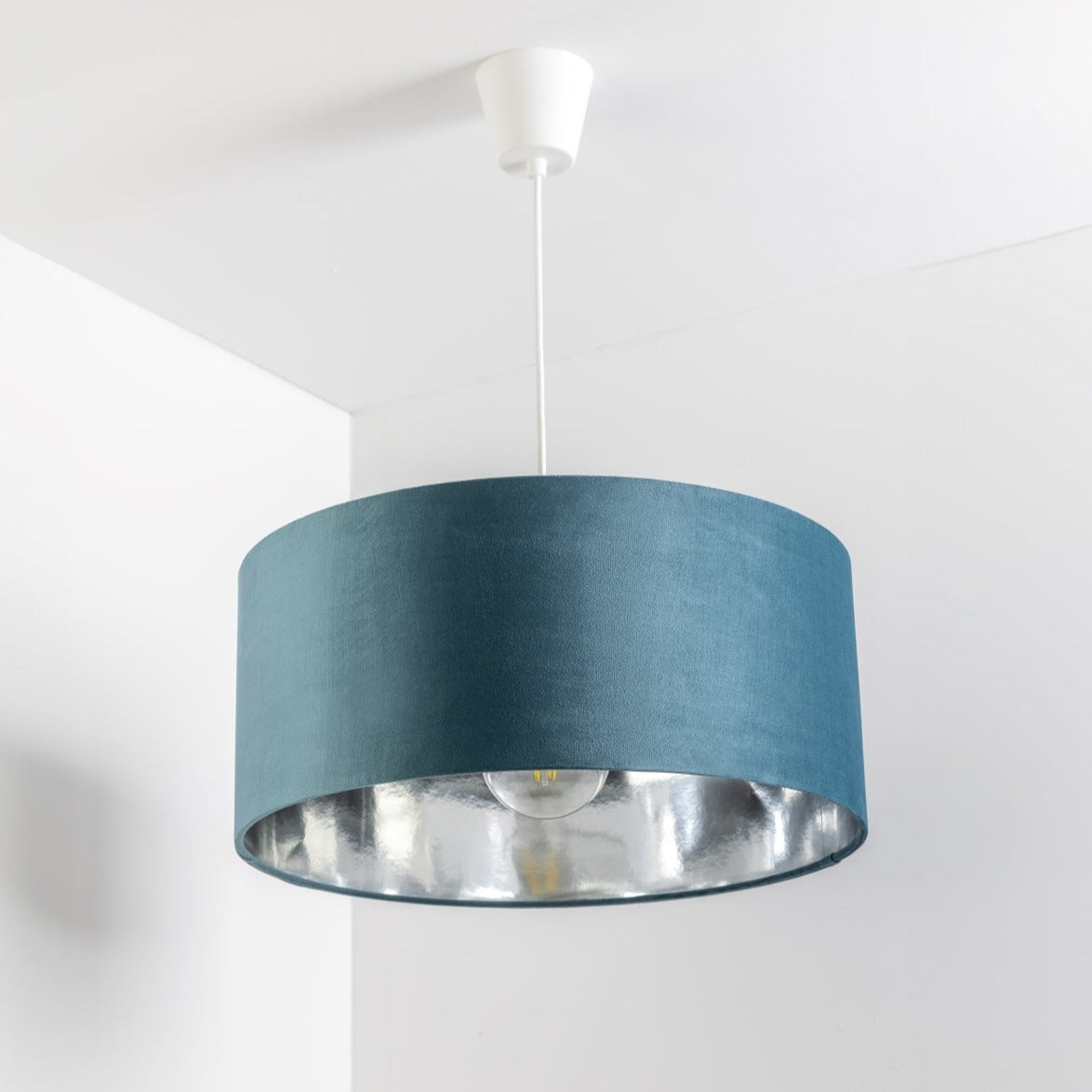 Our stunning oversized Teal blue/green Milano Lamp shade offers a timeless update to any room. The outer is made from high-quality velvet and the lining is reflective silver for a stylish finish. It’s easy to install and will instantly transforms your ceiling fitting, table or floor lamp.