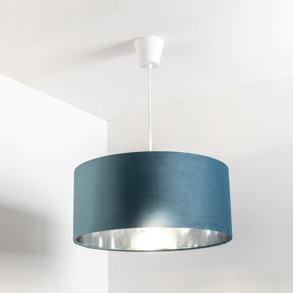 Our stunning oversized Teal blue/green Milano Lamp shade offers a timeless update to any room. The outer is made from high-quality velvet and the lining is reflective silver for a stylish finish. It’s easy to install and will instantly transforms your ceiling fitting, table or floor lamp.