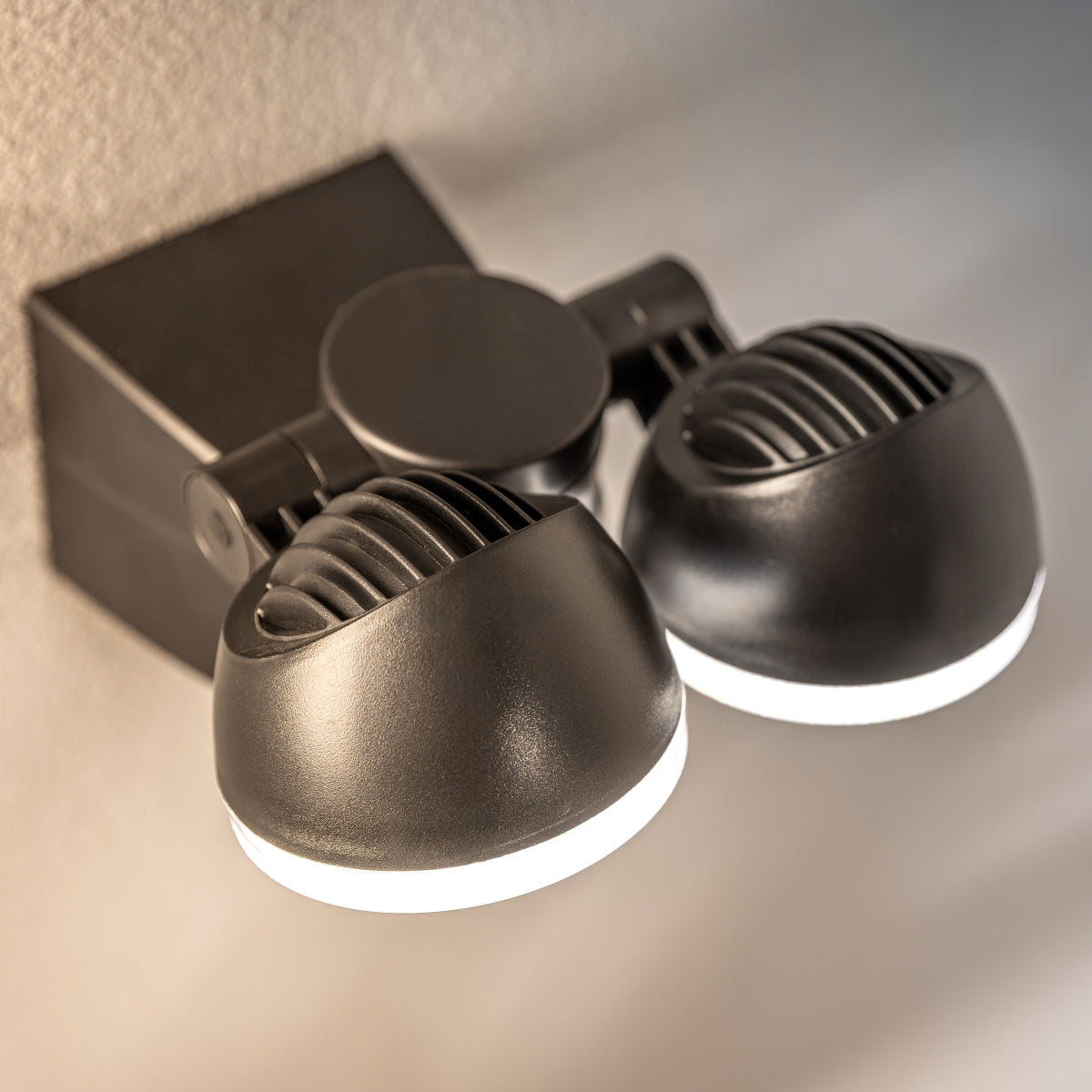 The Martha outdoor double spotlight is a stylish and fashionable outdoor solution for your home.  The easily adjustable heads of this outdoor wall lamp allow it to be used functionally for lighting paths and aesthetically decorate the walls of your home with a beautiful, bright glow. Made from polycarbonate making it rust proof. 